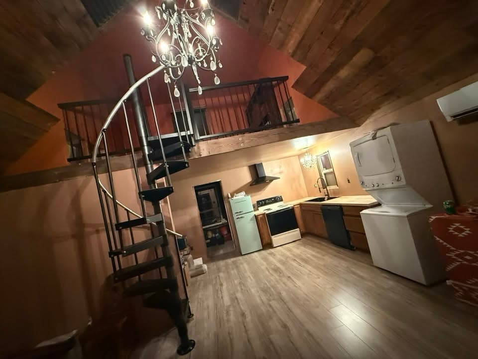 Finished loft remodel with spiral staircase, kitchenette and cedar ceiling by Best Pro Contractors
